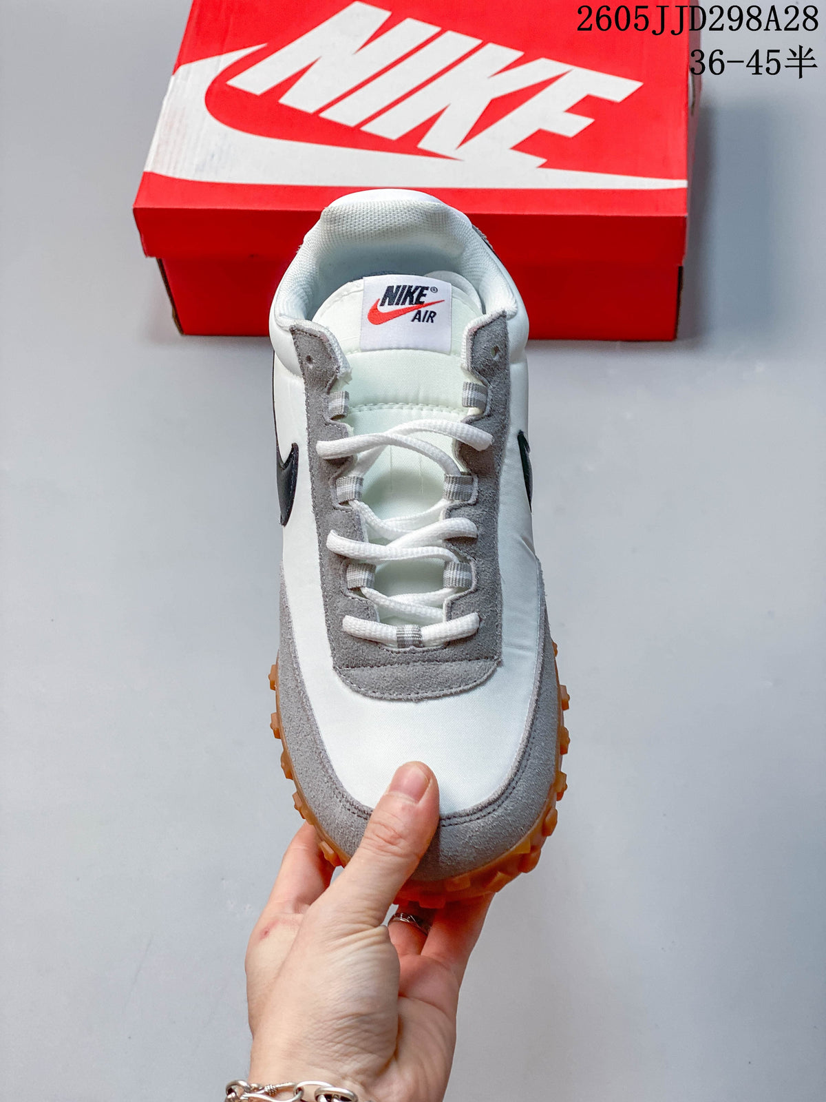 Top view of a Nike Air Max Waffle SP sneaker showing the laces, tongue label, and grey overlays.