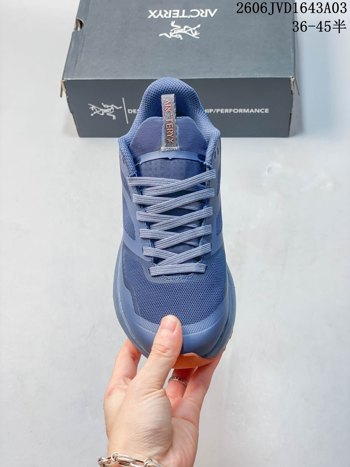 Front view showing the laces and upper of a blue outdoor shoe