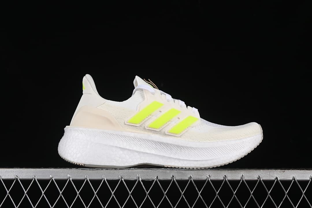 Side profile of the white shoe with lime accents