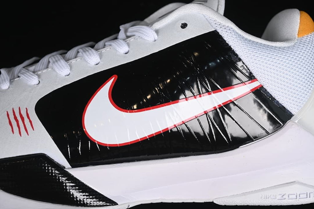 Close-up of the black side panel, white Swoosh with red outline and white midsole