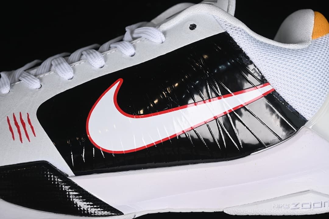Close-up of the black side panel, white Swoosh with red outline and white midsole