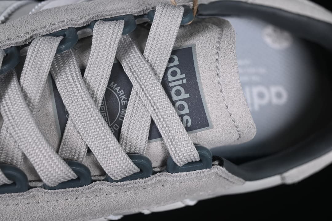 Close-up of gray laces and tongue branding