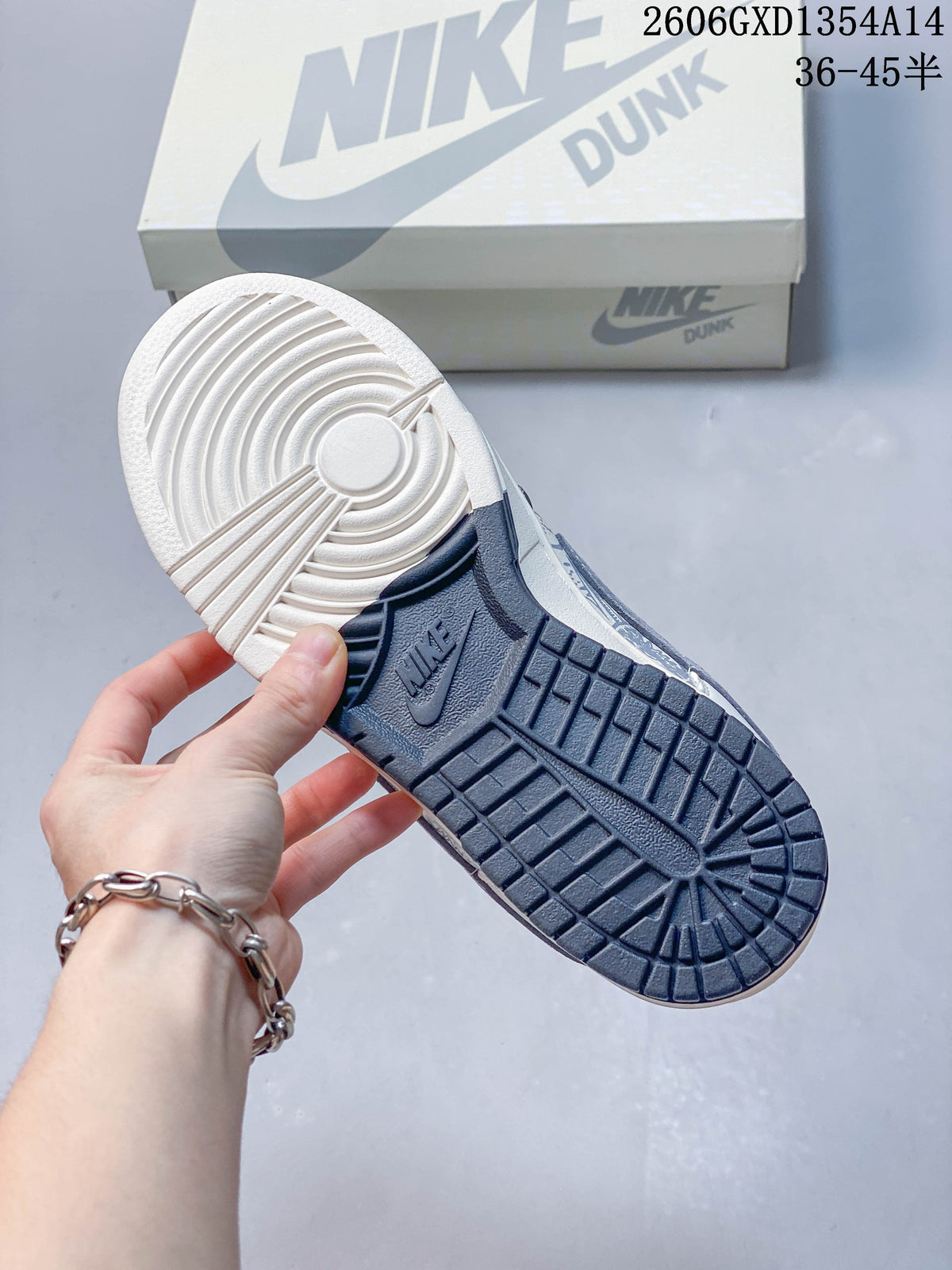 Underside of the sneaker showing a two-tone white and navy outsole