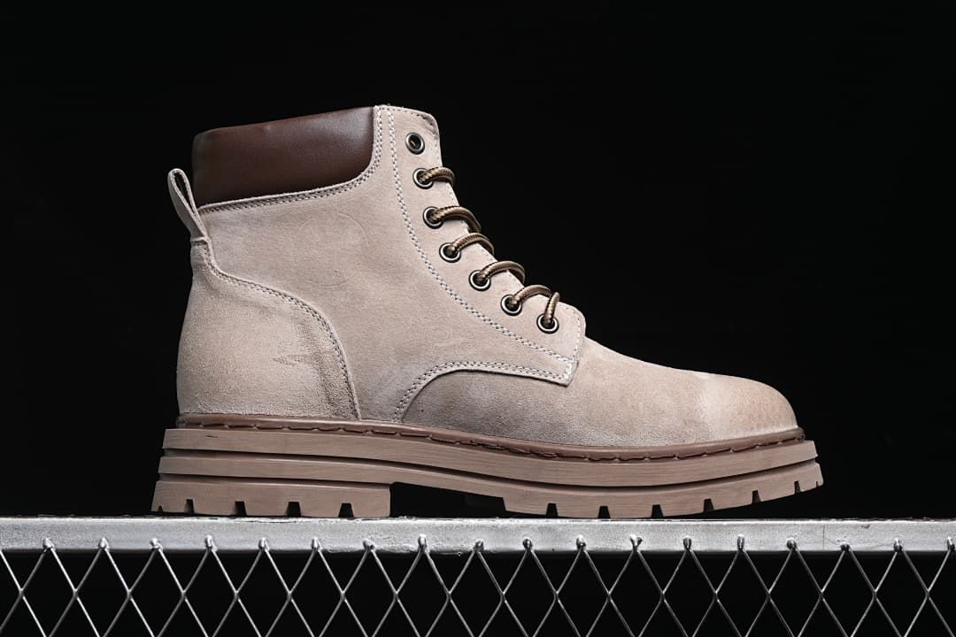 Side profile of a sand-colored high-top boot with a thick brown lugged outsole