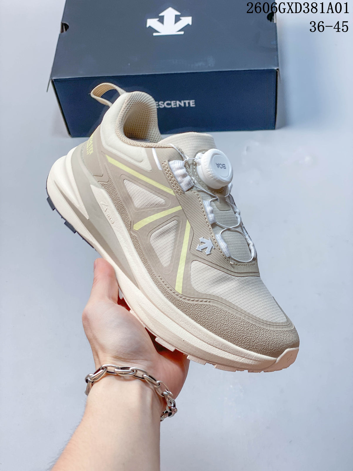 Angled side view of the beige DESCENTE sneaker with dial closure