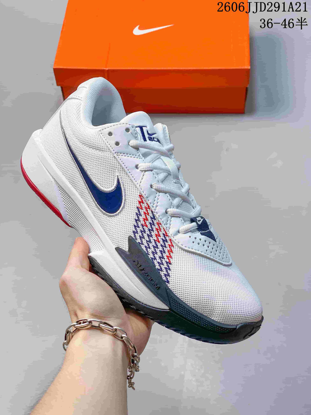 White Nike G.T. Cut 3 basketball shoe with navy and red side details and a dark outsole.