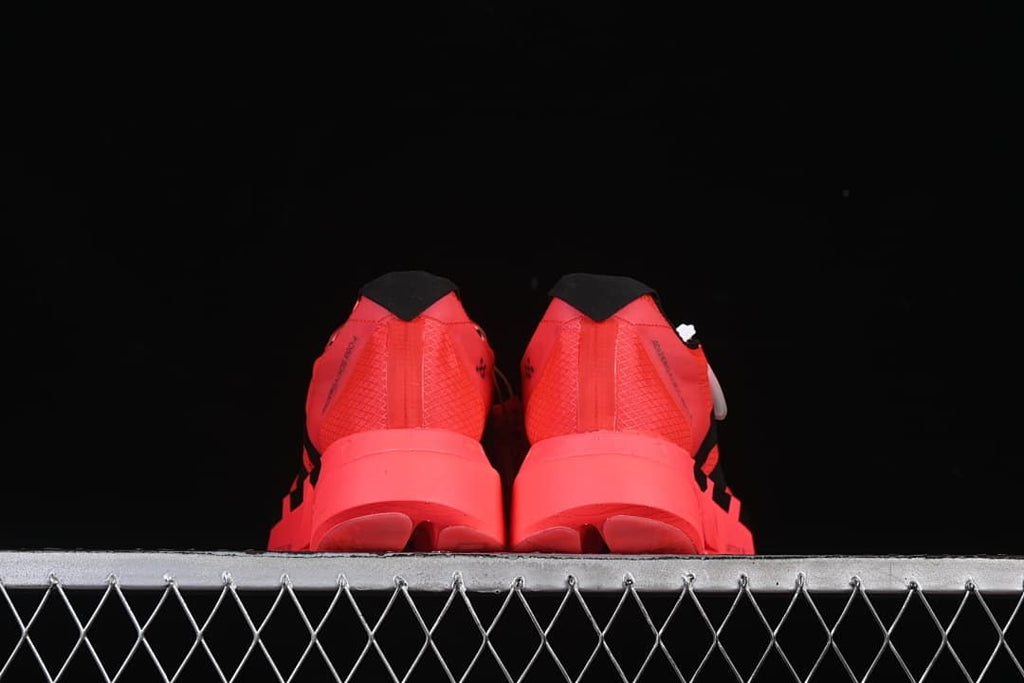 Rear view of both shoes highlighting the heels and soles