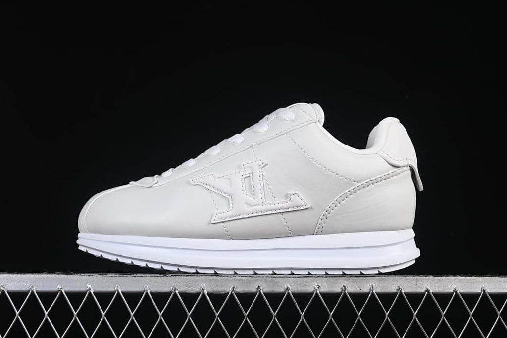 White low-top lace-up sneaker shown in profile