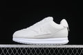 White low-top lace-up sneaker shown in profile