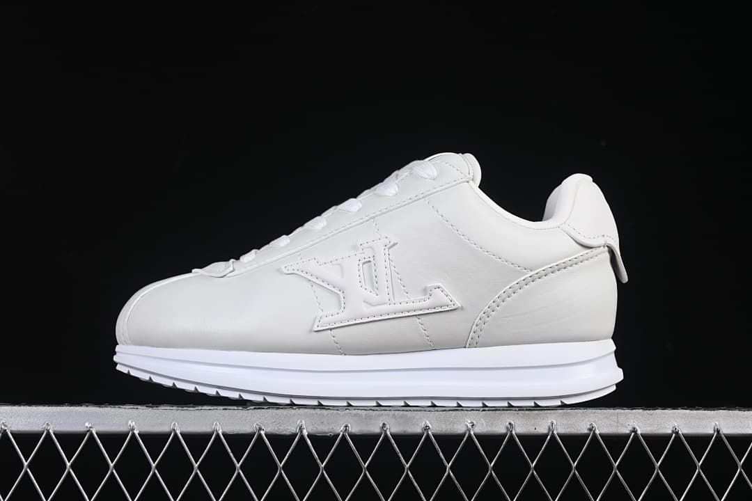 White low-top lace-up sneaker shown in profile