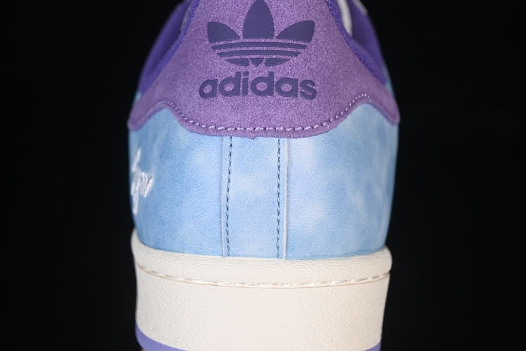 Rear view of the sneaker with purple heel tab and light blue panels