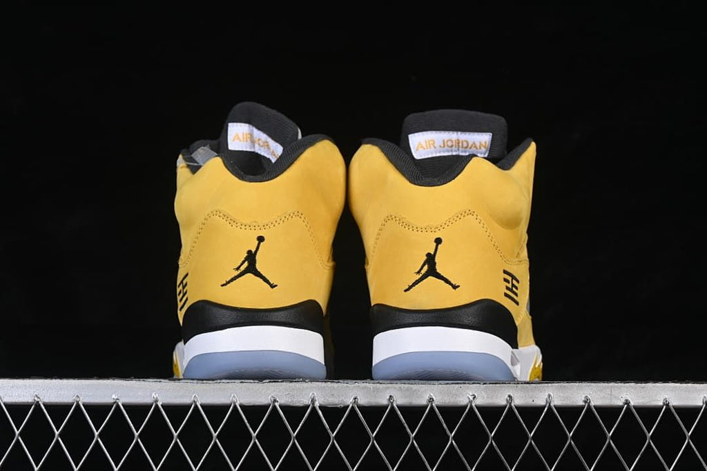 Rear view of the pair showing black heel logos and yellow uppers