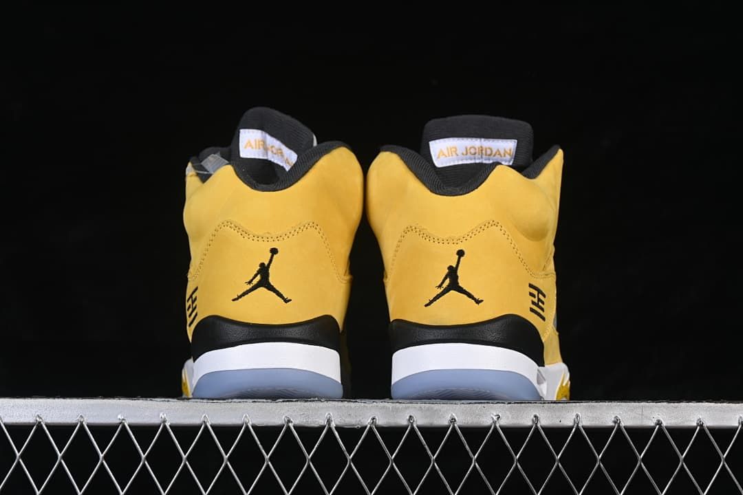Rear view of the pair showing black heel logos and yellow uppers