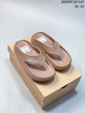 Pair of taupe Nike Calm thong-style slide sandals on a box; image overlay shows sizes 36–45 and style code 2606HY307A07.