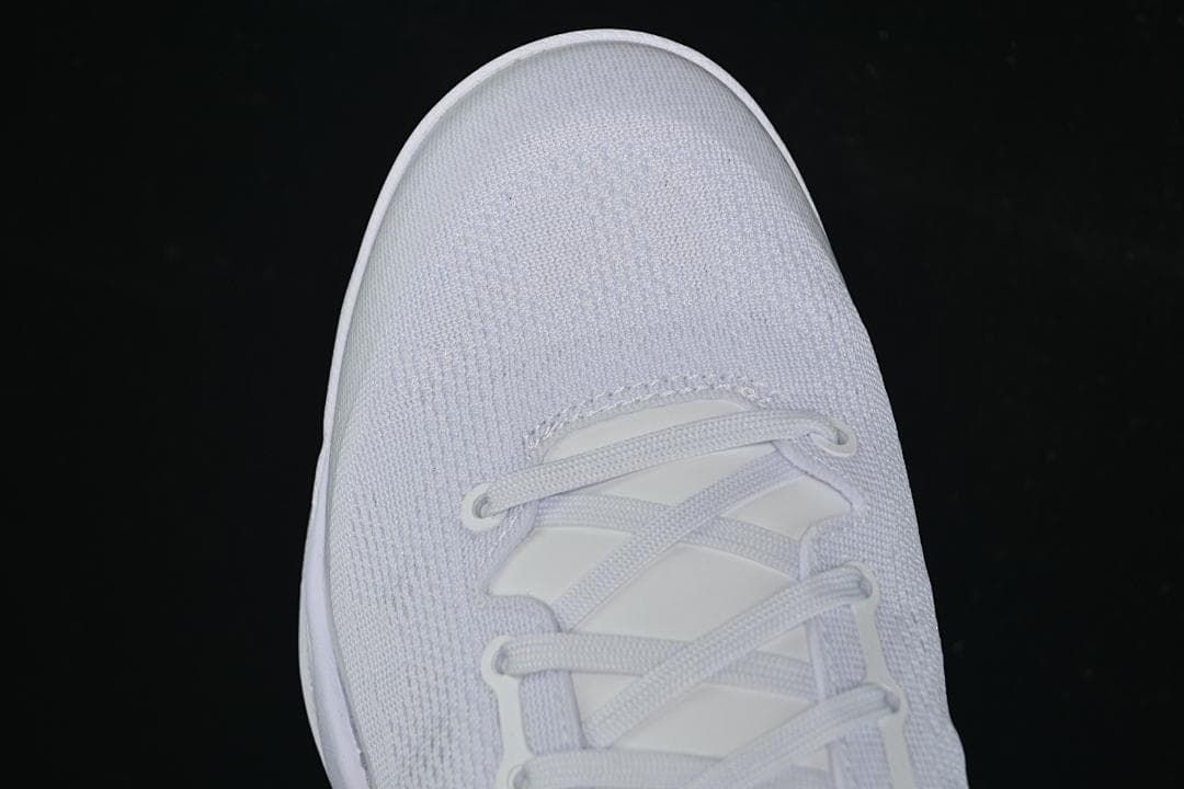 Top-down view of the white knit-textured toe and lacing