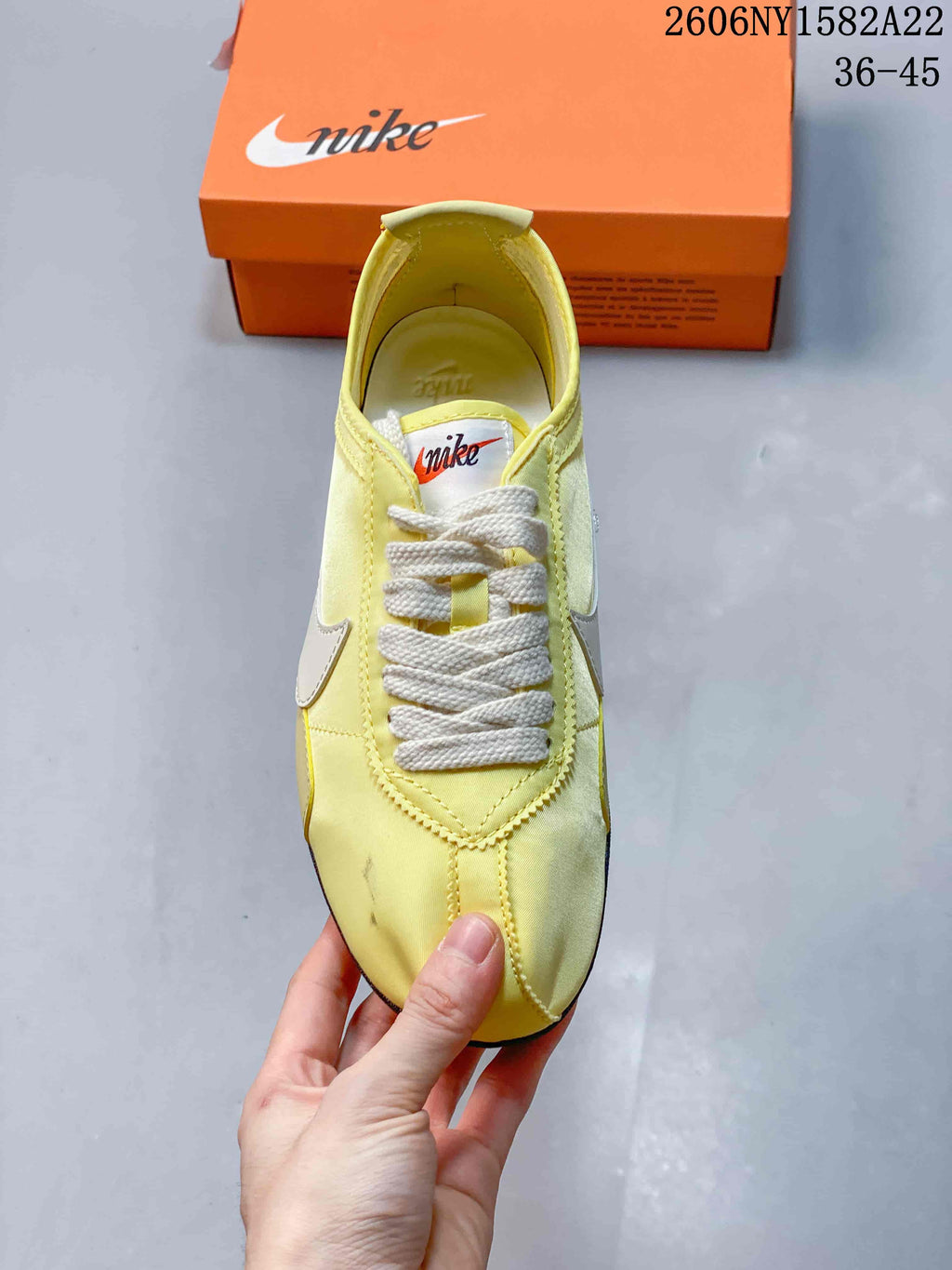 Top view of a pale yellow Nike Moon Shoe OG sneaker with cream laces