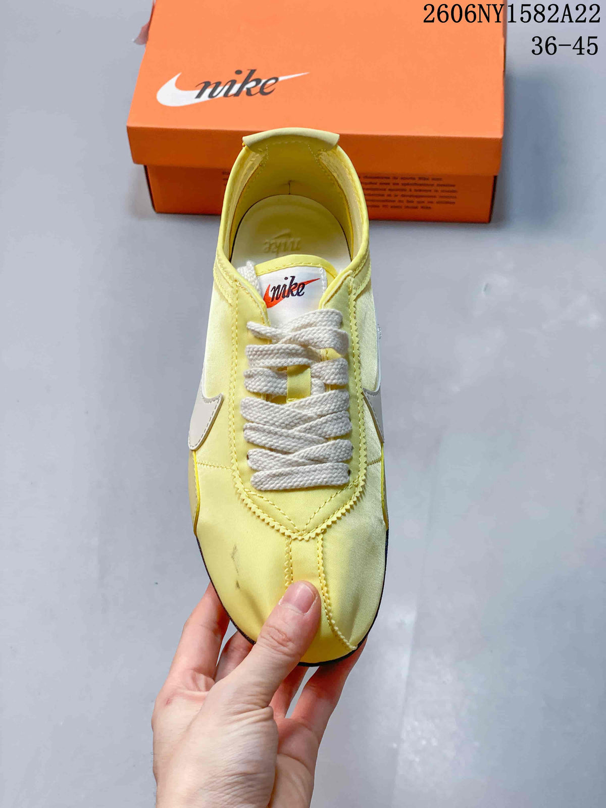 Top view of a pale yellow Nike Moon Shoe OG sneaker with cream laces