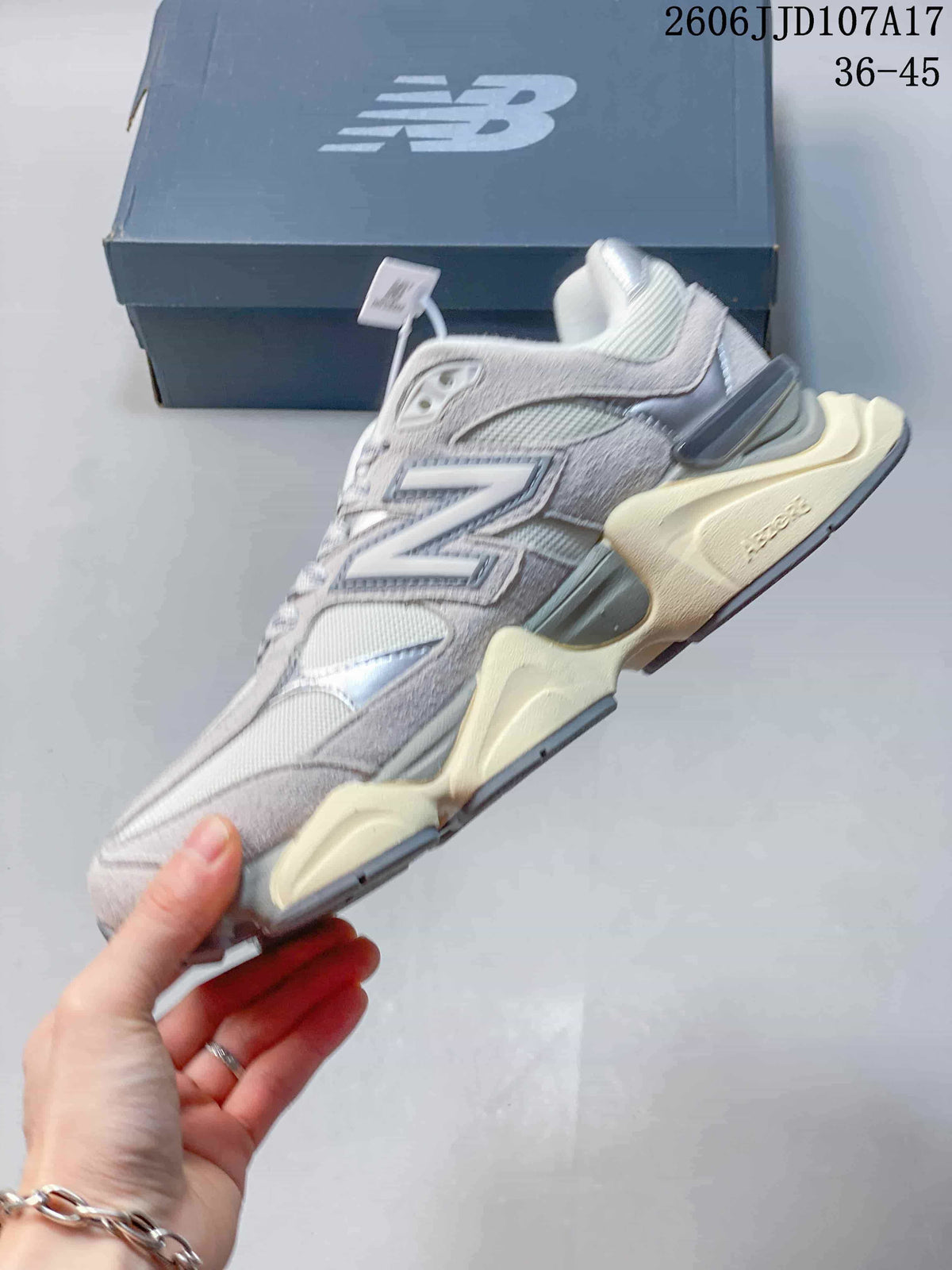 Side profile of a grey and silver New Balance 9060 sneaker
