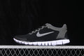 Side profile of black and grey Nike Free 3.0 sneakers with a white segmented outsole.