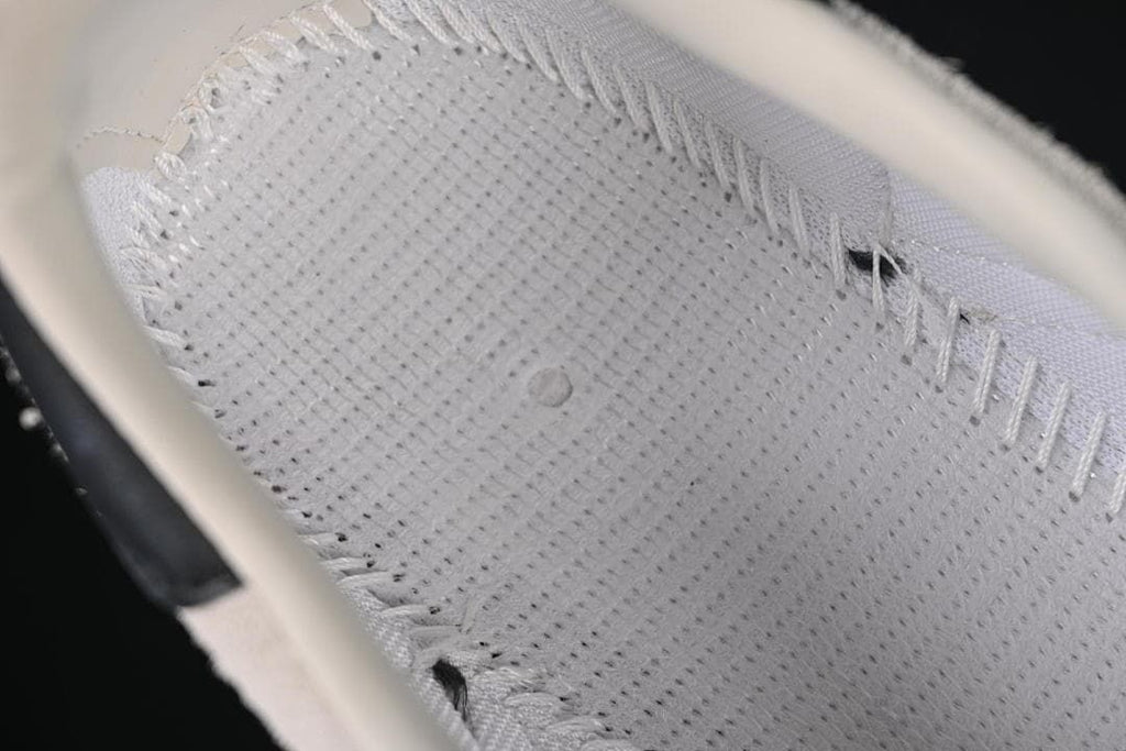 Close-up of the sneaker's light-colored tongue and lace area