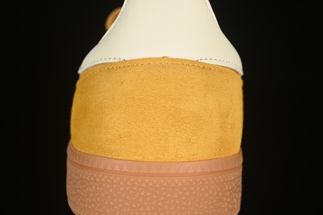 Rear view showing the cream heel panel, yellow upper and gum-colored sole