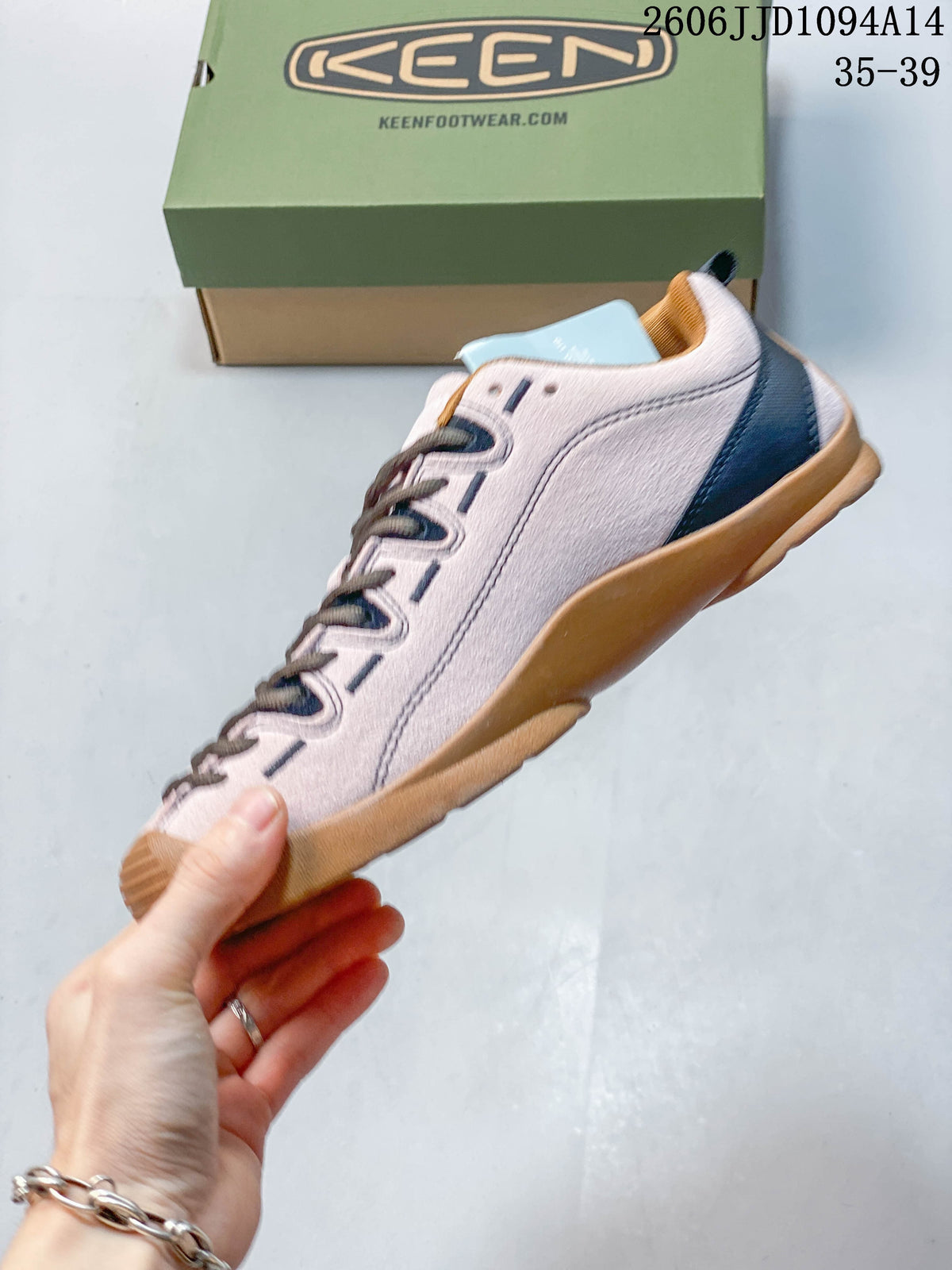 Side view of a pale pink KEEN Jasper low-top sneaker with navy accents