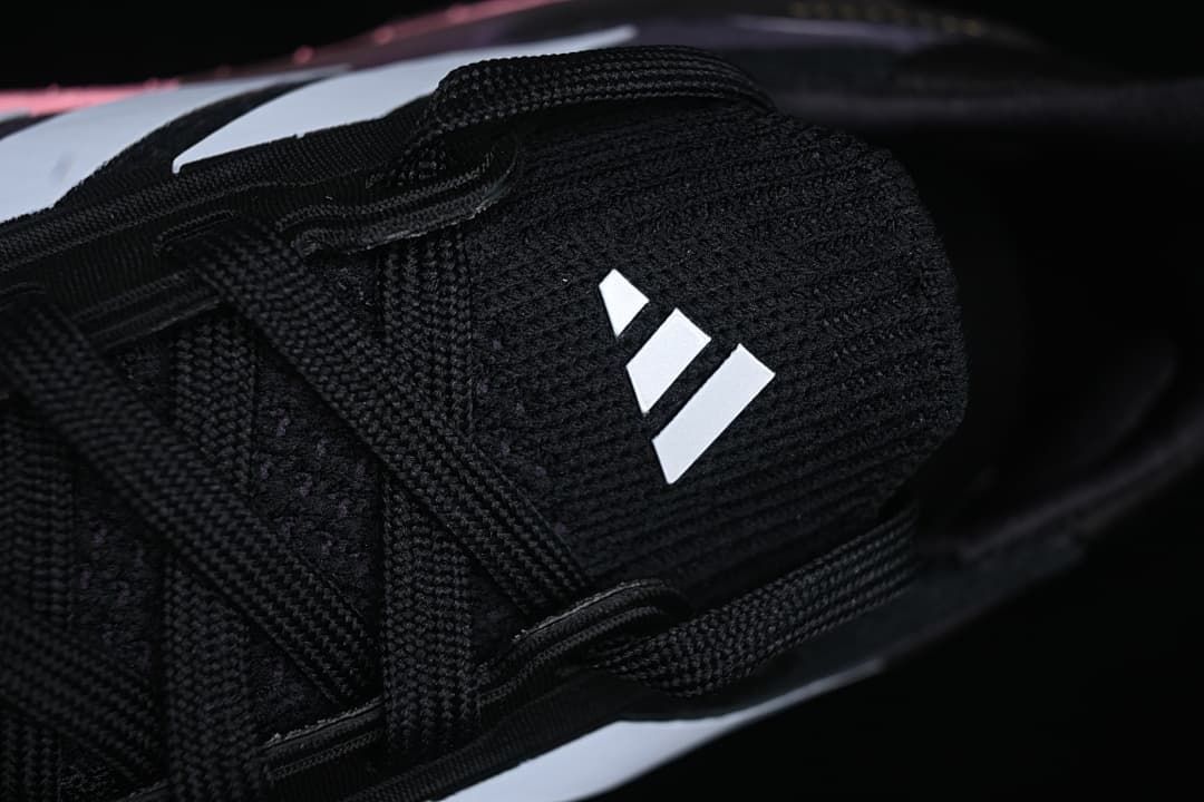 Top close-up of the black tongue and white adidas logo.
