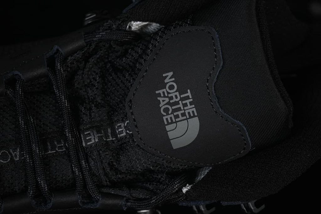 Close-up of the boot tongue logo, laces and upper.
