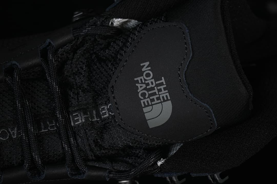Close-up of the boot tongue logo, laces and upper.