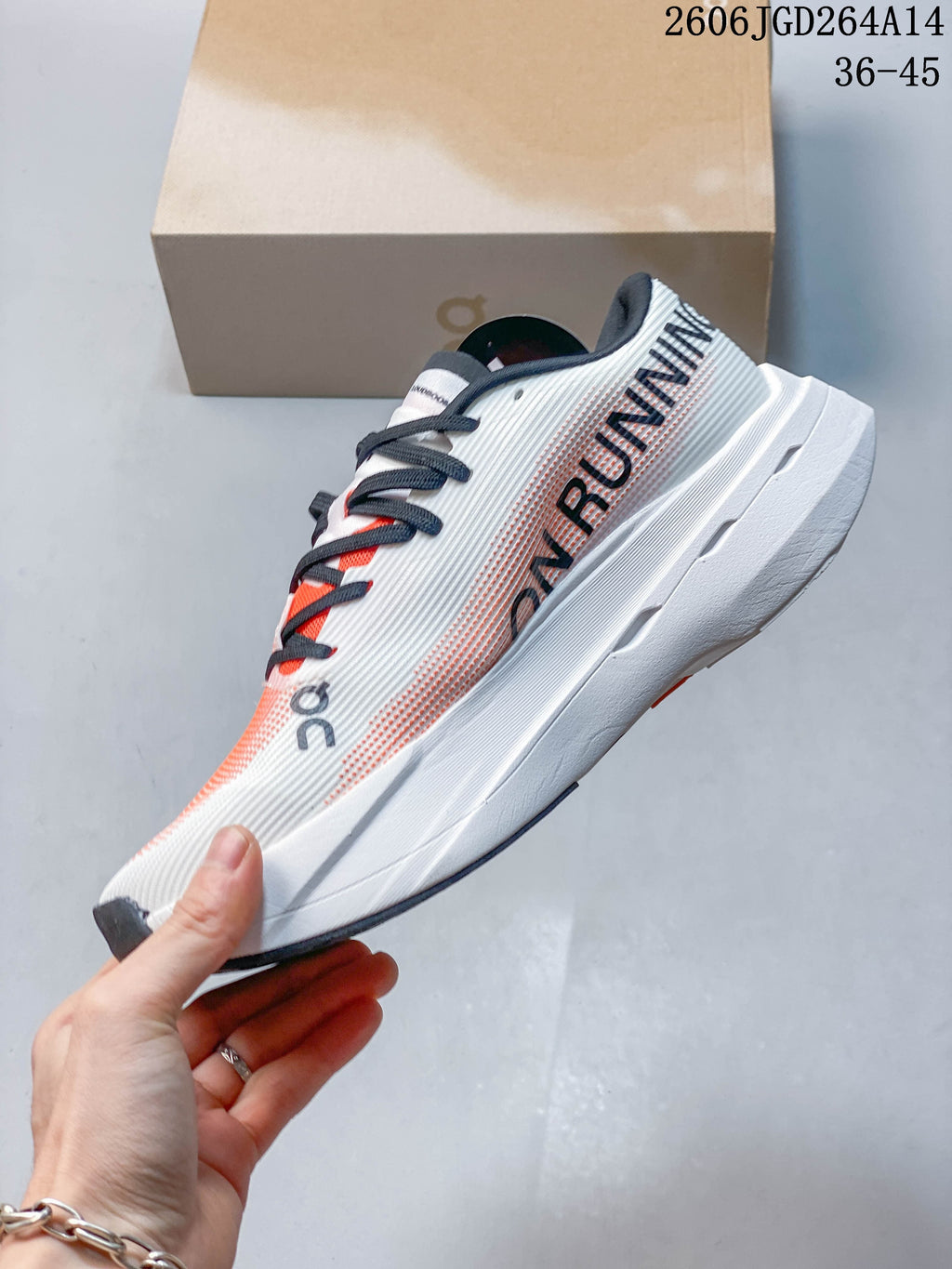 Side view of an On Cloudboom Volt shoe with coral-patterned upper and white sole