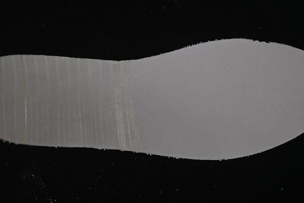 Close-up of the sneaker outsole edge against a dark background
