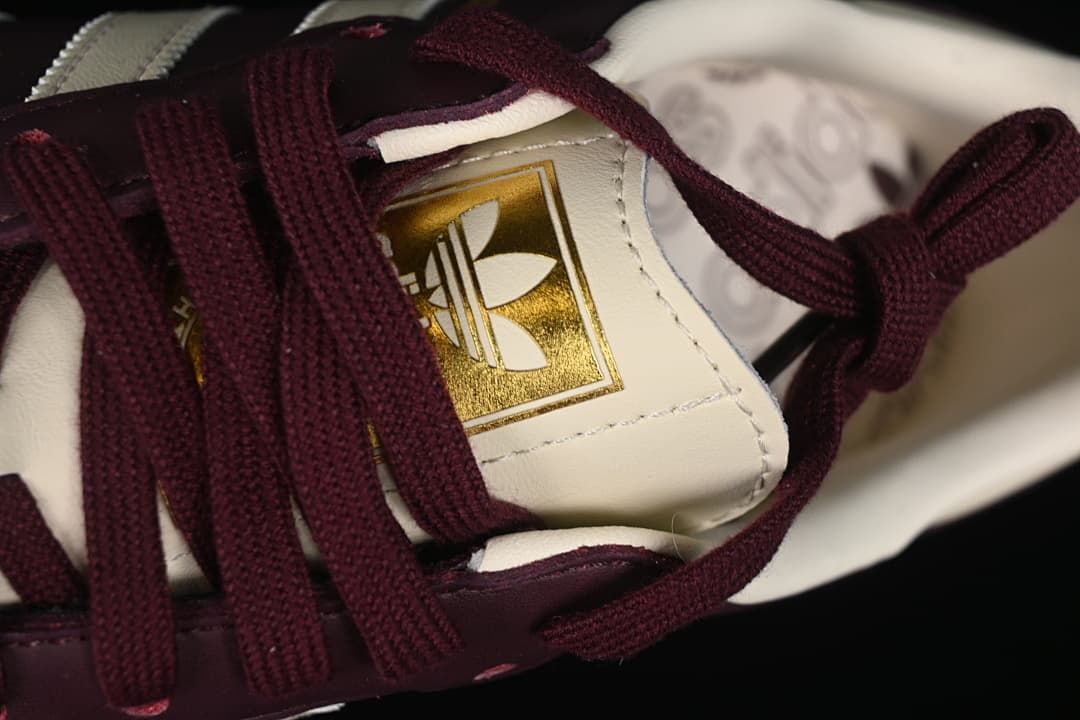 Close-up of the tongue label and burgundy laces