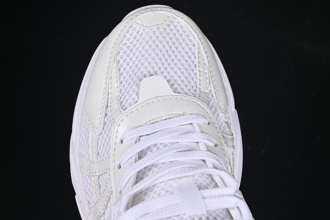 Top-down close-up of the sneaker toe, mesh panel, and laces