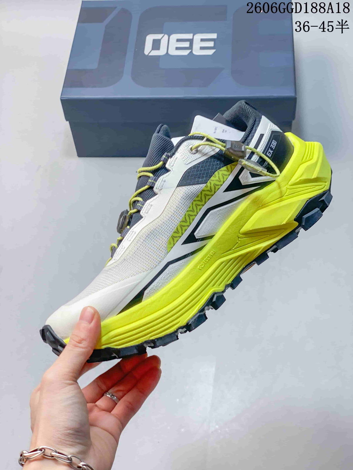 Side profile of a white and neon yellow Kailas FUGA EX330 trail shoe with dark accents; image text shows style code 2606GGD188A18 and size range 36–45.5.