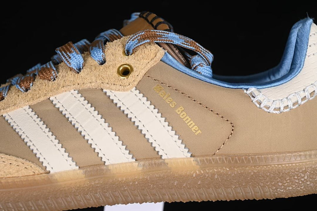 Close-up of cream stripes, tan upper, blue collar and gum-look sole