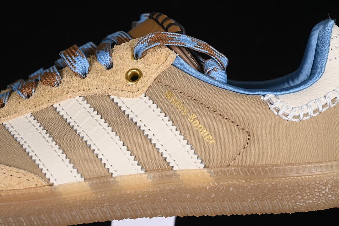 Close-up of cream stripes, tan upper, blue collar and gum-look sole