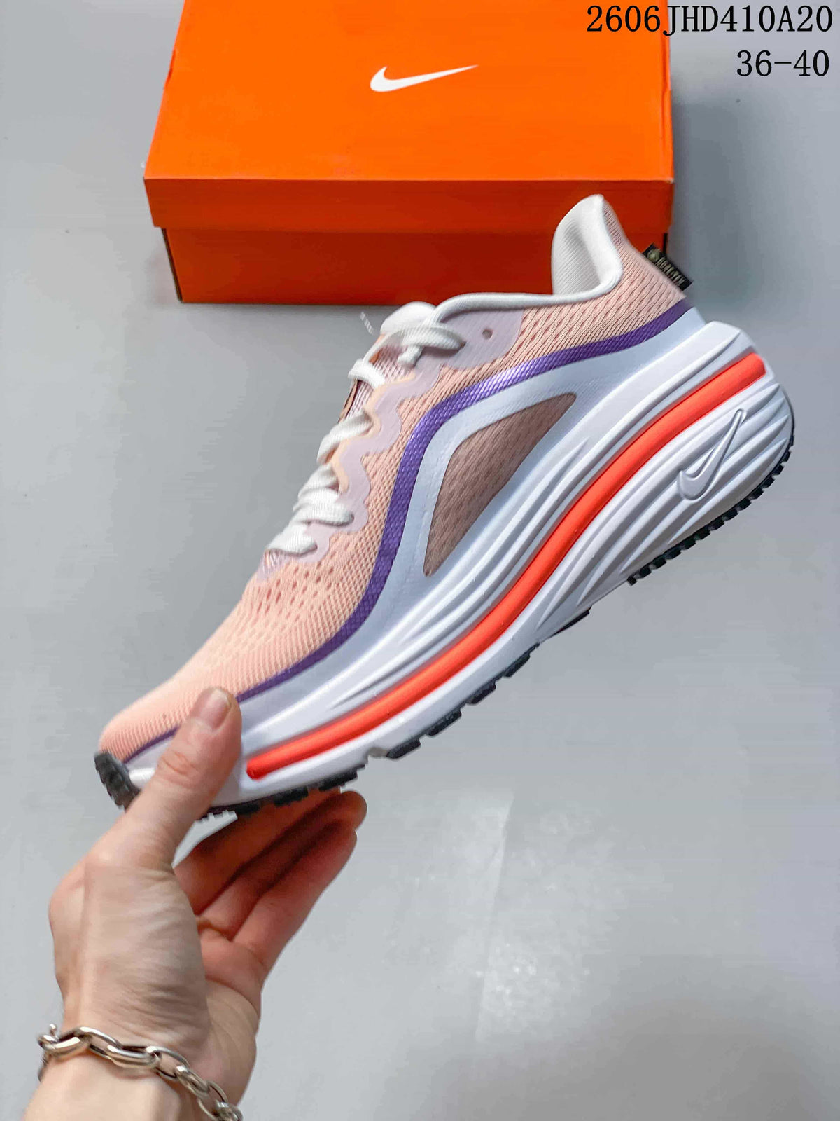 Side profile of the pink-toned Nike Air Zoom Winflo 12 running shoe