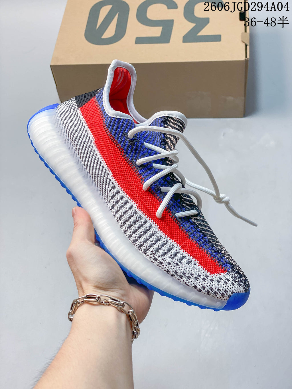A group of Adidas Yeezy-style low-top sneakers in assorted colors arranged in a circle.