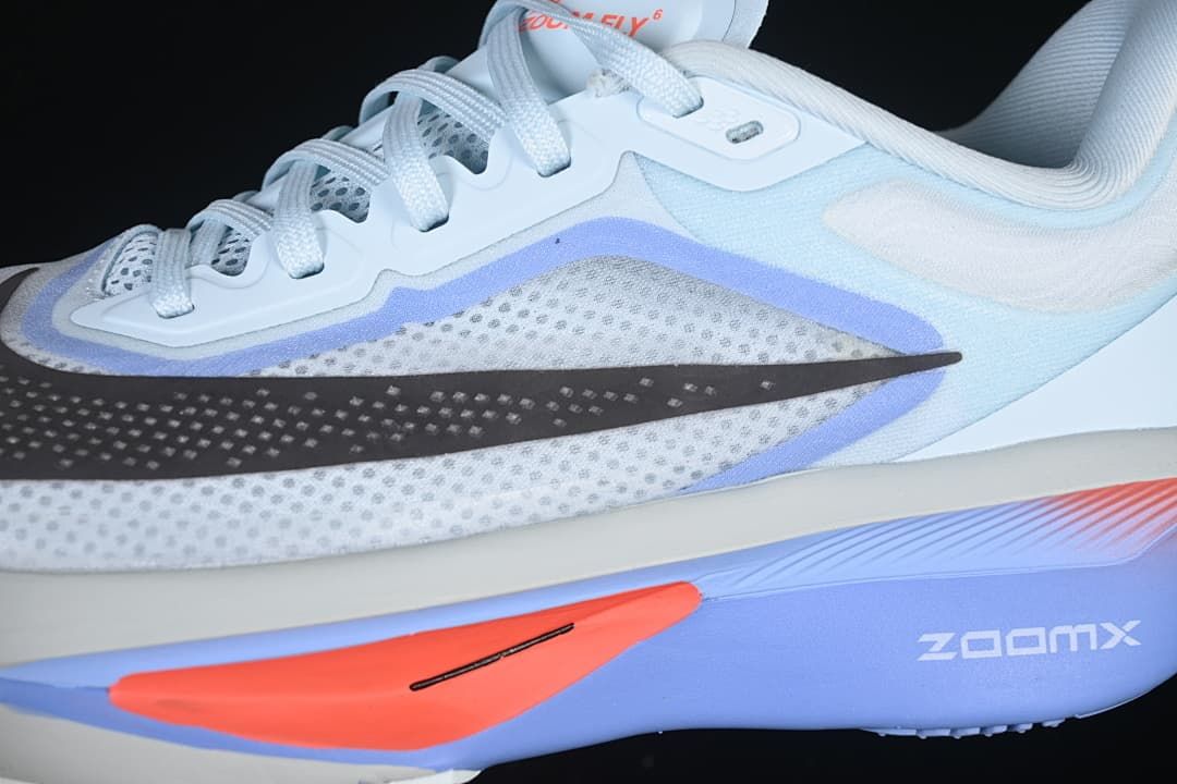 Close-up of the shoe's side, perforated-looking upper, Swoosh, and ZoomX-marked sole.