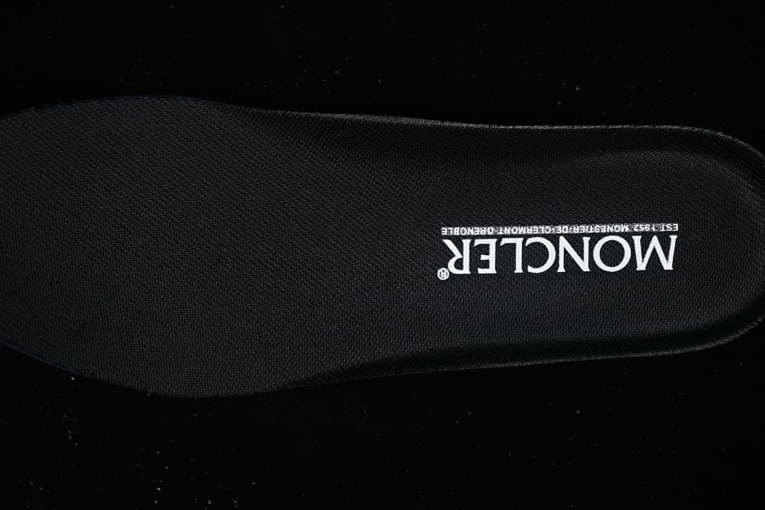 Close-up of a black Moncler-branded insole.