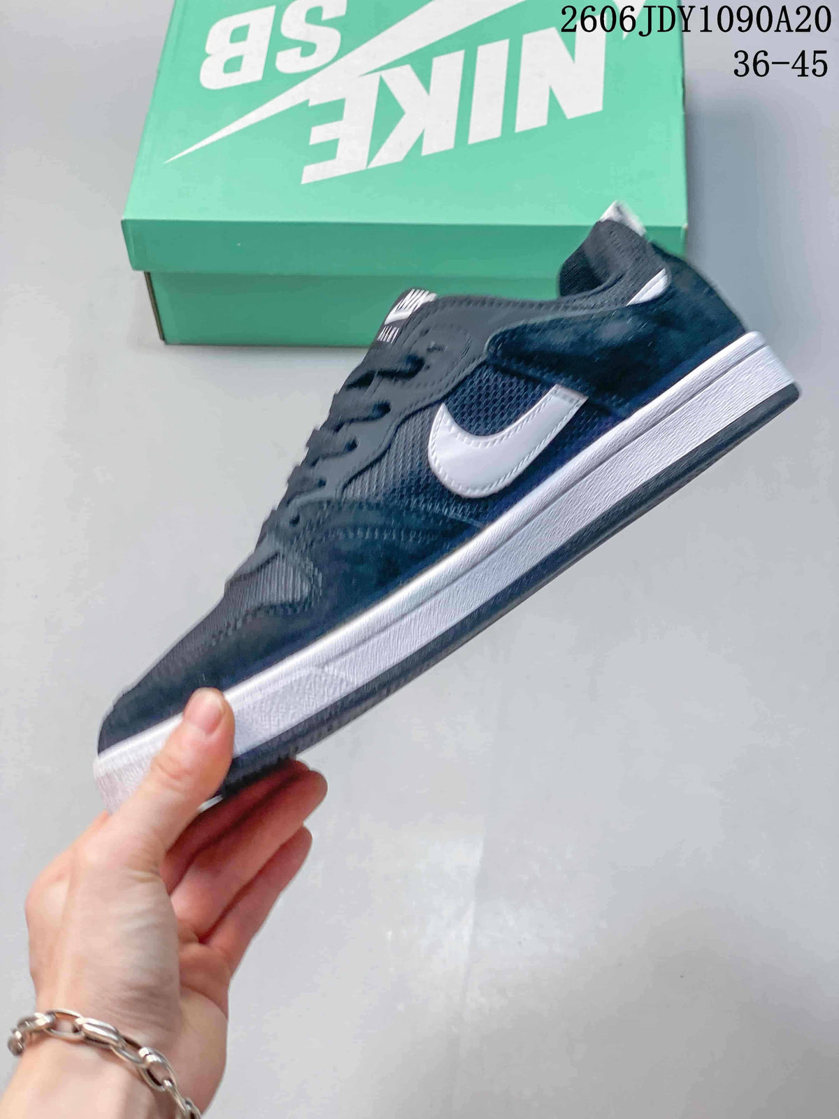 Side view of a navy Nike SB Alleyoop shoe with a white Swoosh and midsole