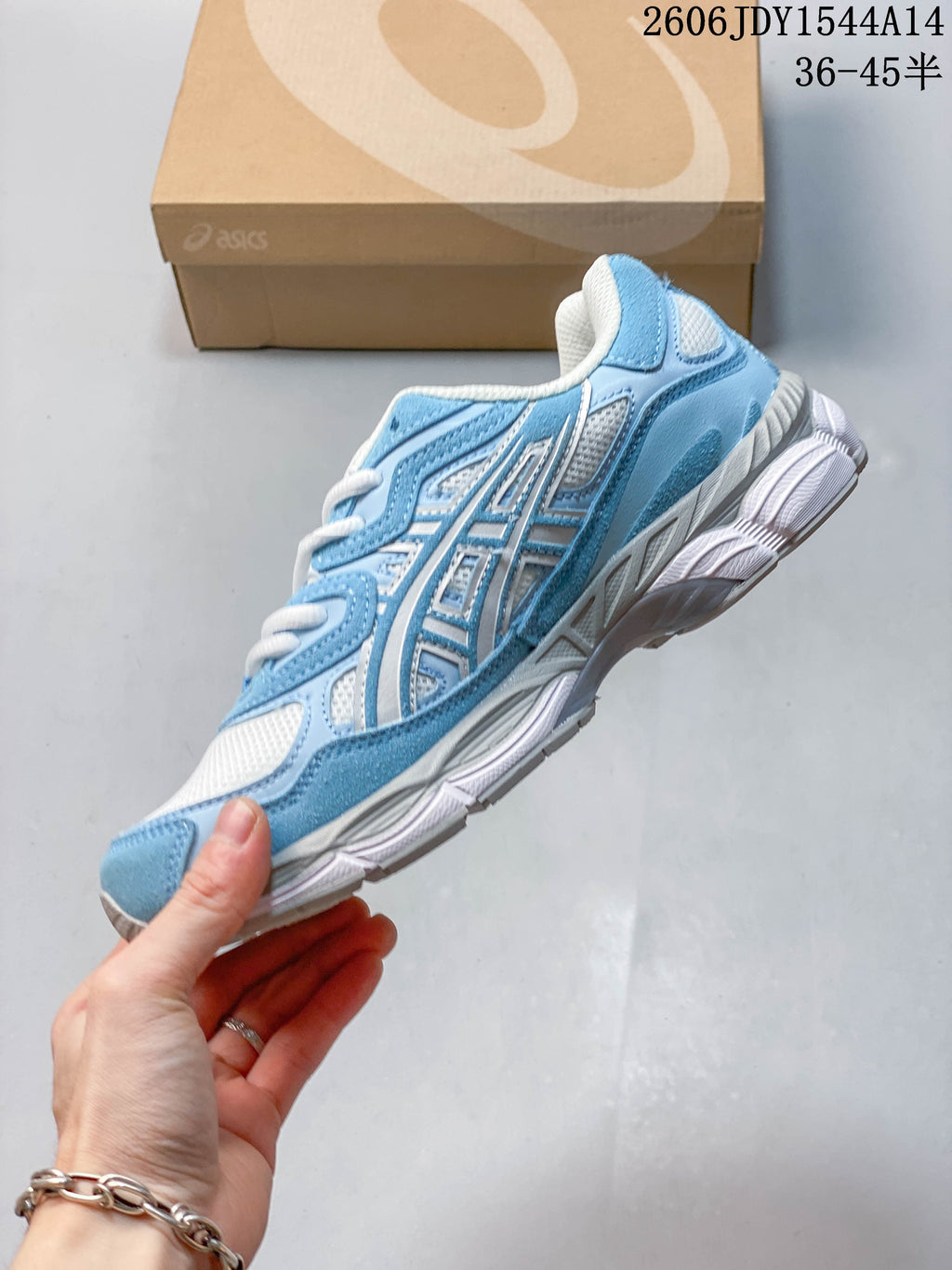 Side view of a blue and white ASICS GEL-NYC sneaker.