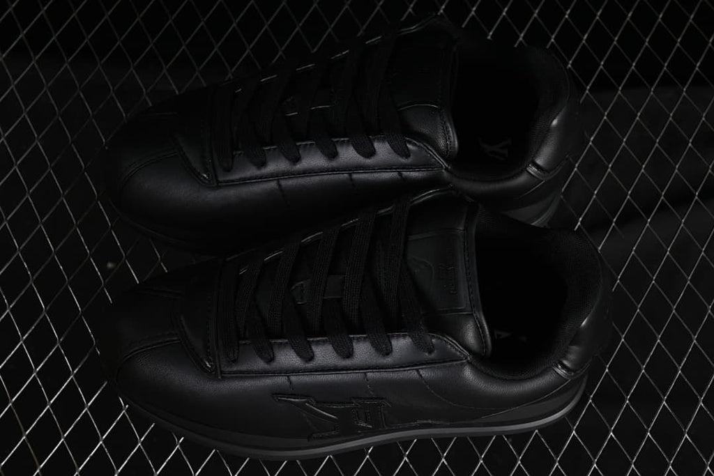 Pair of black low-top sneakers viewed from above