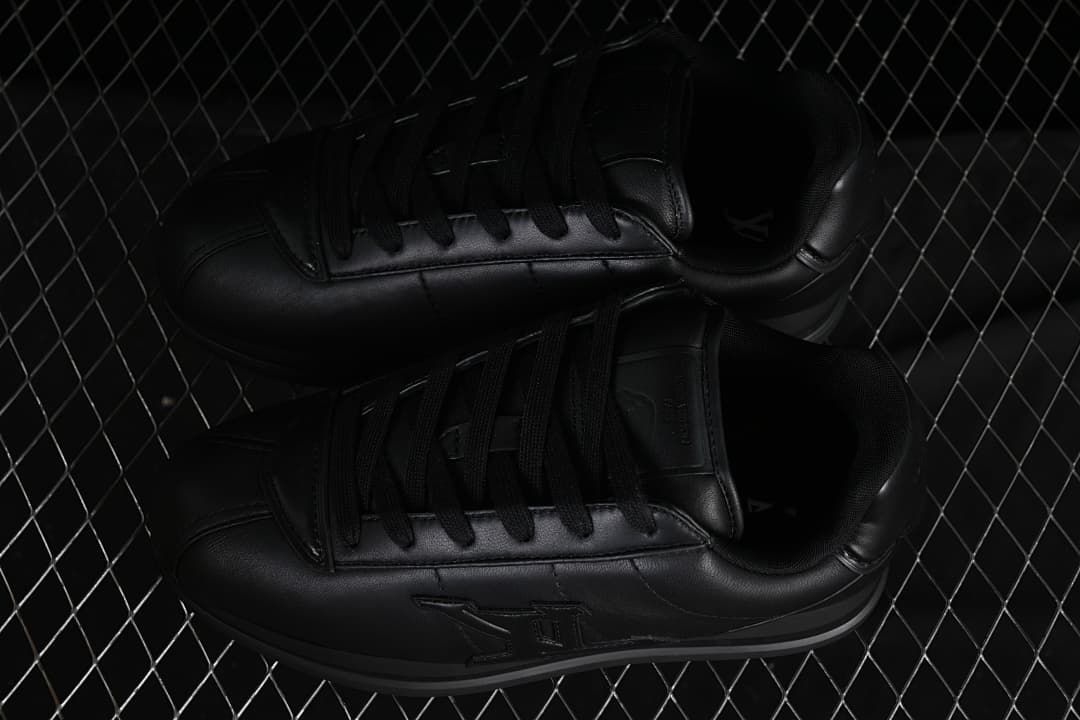 Pair of black low-top sneakers viewed from above