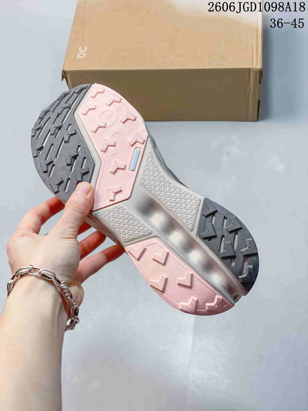 Close-up of the Cloudmonster 3 outsole with contrasting gray and pale pink tread