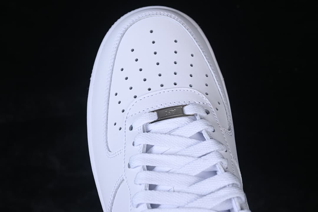 Top-down detail of the perforated toe, laces and metal lace tag