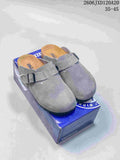 Pair of gray Boston-style clogs with buckle straps on a branded box