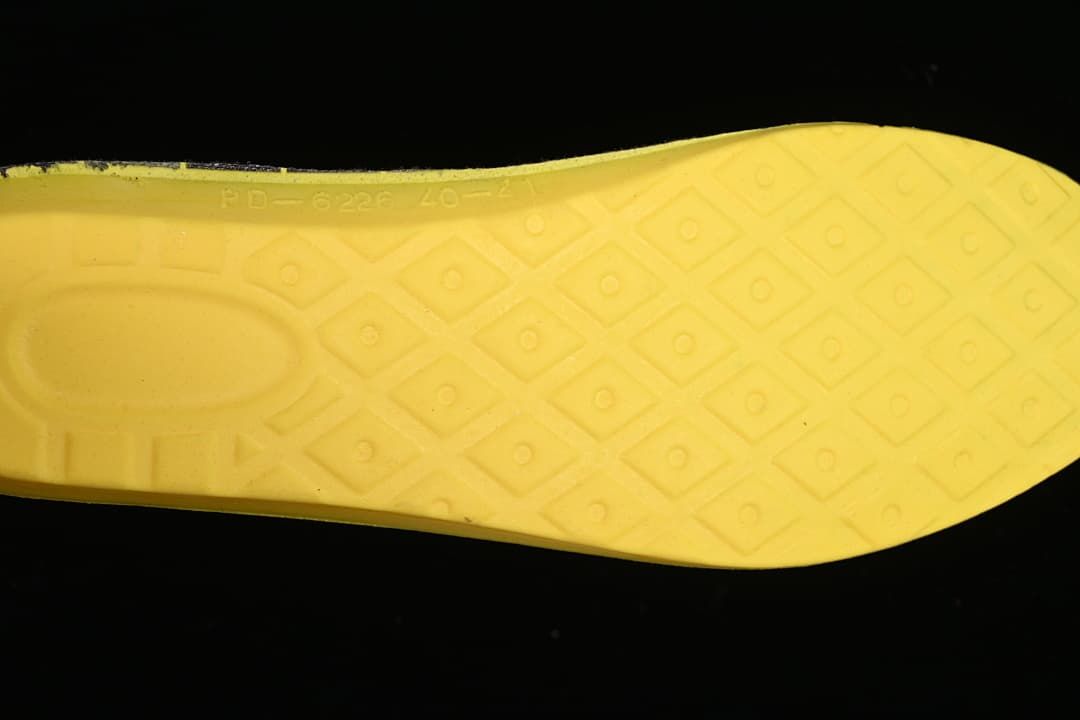 Close-up of the boot's yellow insole with a geometric pattern and size markings.