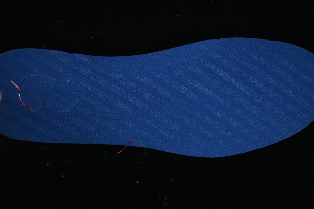 Blue insole shown against a dark background