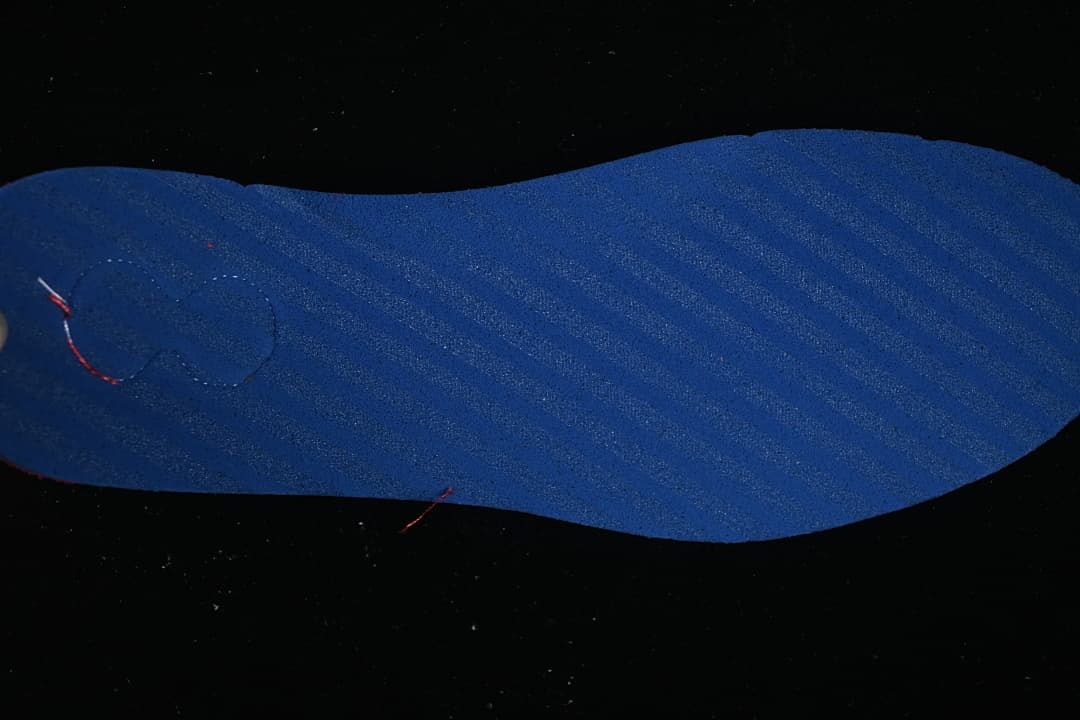 Blue insole shown against a dark background